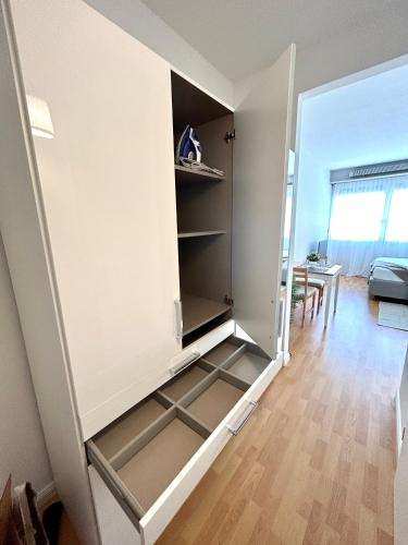 a small room with a closet with shelves at Modern Studio near Lugano's Lake & City Center in Lugano