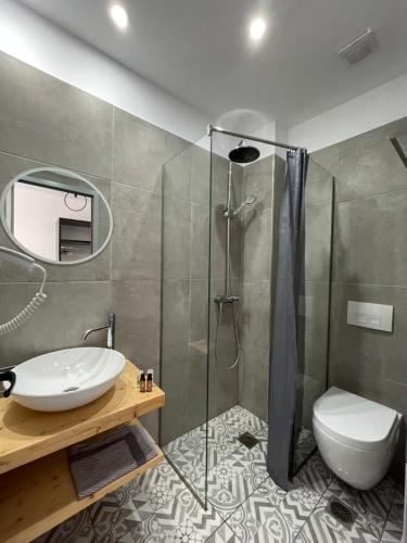 a bathroom with a sink and a shower at Orchard Retreat in Himare