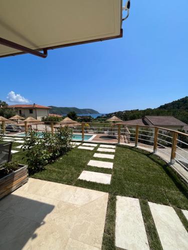 a backyard with a pool and a fence at BnB Il Grecale in Lacona