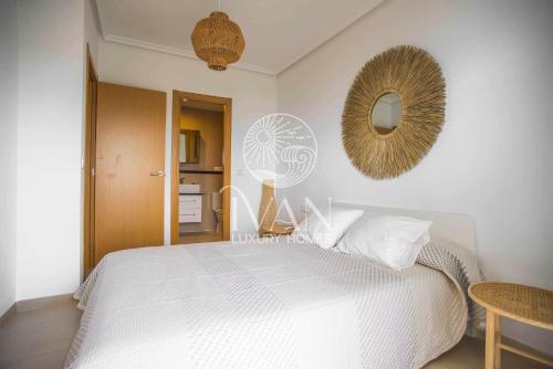 a bedroom with a white bed and a mirror at Casa Caribe Ivan Luxury Homes 7ªPlta Frontal 1ªLinea in Oropesa del Mar