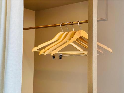 a closet with a rack of wooden hangers at Edge Central Pattaya Vip Condo in Pattaya Central