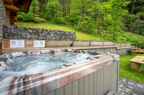 a hot tub with polar bears in it in the woods at Chalet Durik Bystra - Jacuzzi - Sauna - In the forest - 10 min walk to restaurant - On hiking trail in Horná Lehota