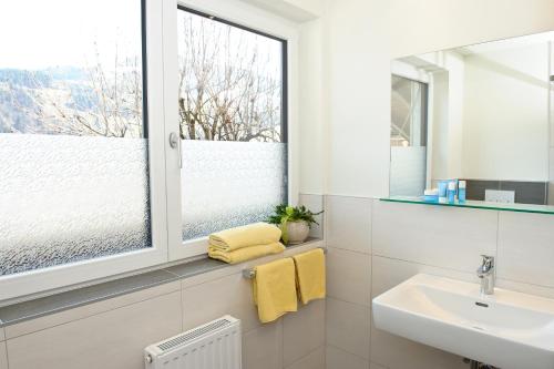 a bathroom with a sink and a window at Gasthaus Bacher in Sankt Johann im Pongau
