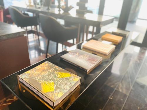 a glass table with books on top of it at Edge Central Pattaya Vip Condo in Pattaya Central