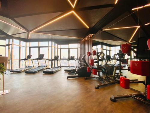 a gym with several treadmills and cardio machines at Edge Central Pattaya Vip Condo in Pattaya Central