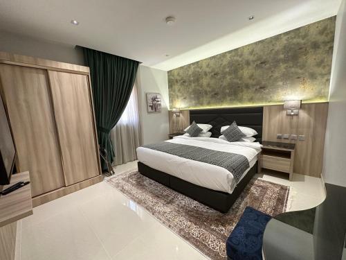 a bedroom with a large bed and a large window at Mehad Stay for Self Check-In Apartment in Jeddah
