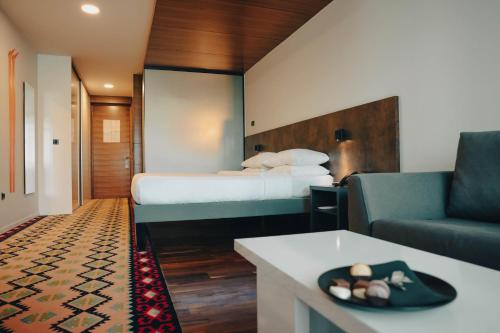 pokój hotelowy z łóżkiem i kanapą w obiekcie ibis Styles Sarajevo w Sarajewie
