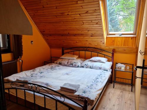 a bedroom with a bed in a log cabin at Chalupa Zvičina 
