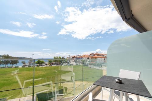a room with a large window with a view of a field at Thetis Boutique Apartments in Neos Marmaras
