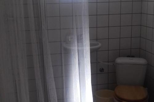 a bathroom with a toilet and a shower with a shower curtain at Návrat do starých časů, ubytování květen - září in Slabce
