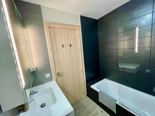 a bathroom with a tub and a sink and a bath tub at Casa Mae in Caleta De Fuste