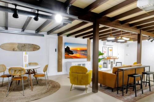 a living room with a table and chairs and a dining room at *NEW* The Surf Shack Jupiter! in Tequesta