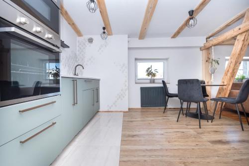 a kitchen with a table and chairs in a room at Apartament Nowy Świat 1 in Gliwice