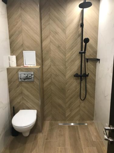 a bathroom with a toilet and a shower at SPA Apartments Perun in Sandanski