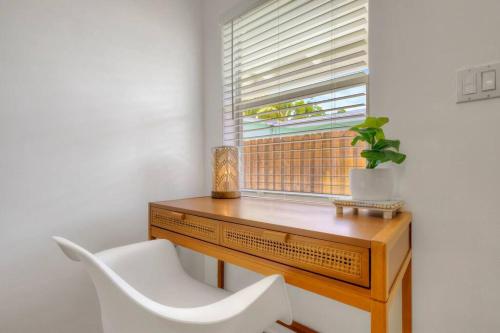 a desk with a white chair and a window at *NEW* The Surf Shack Jupiter! in Tequesta