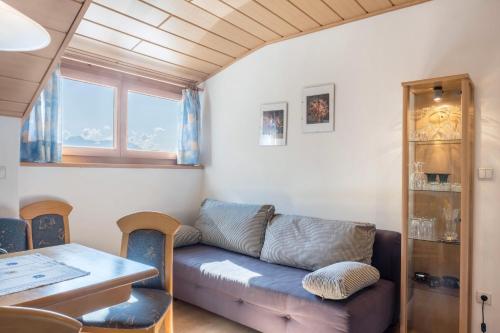 a living room with a couch and a table at Weingartnerhof Dalia in San Genesio Atesino