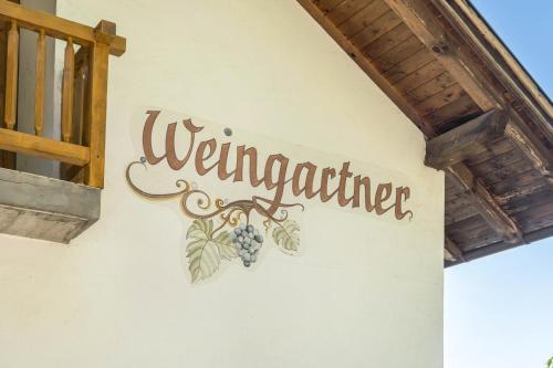 a welcome sign on the side of a building at Weingartnerhof Dalia in San Genesio Atesino