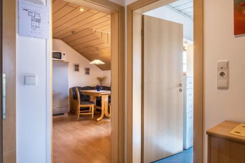 a door leading into a room with a table at Weingartnerhof Dalia in San Genesio Atesino