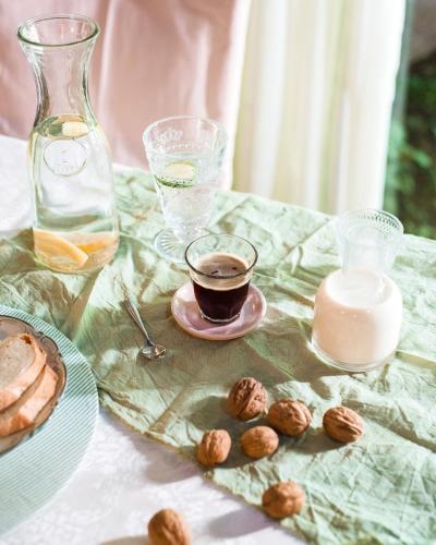 a table with a cup of coffee and a plate of nuts at Casa Lila in Mendoza
