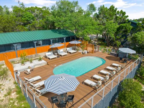 an overhead view of a pool with chairs and umbrellas at The Bygone in Wimberley