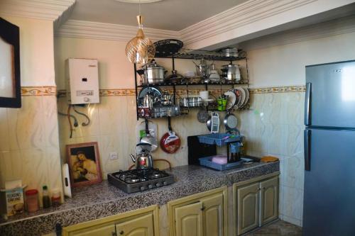 a kitchen with a refrigerator and a counter top at Private appartement in the centre of Taghazout in Taghazout