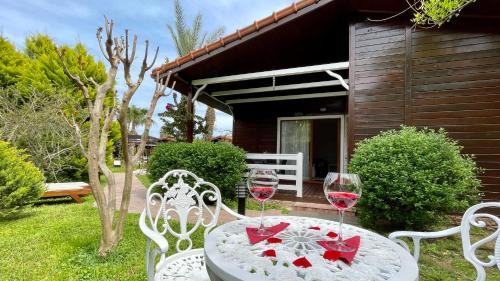 a table with two glasses of red wine at Aida Hotel in Cıralı