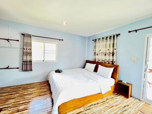 a bedroom with a large white bed and a window at Sai Klong Song Lae Resort Pakpra Phatthalung in Phatthalung