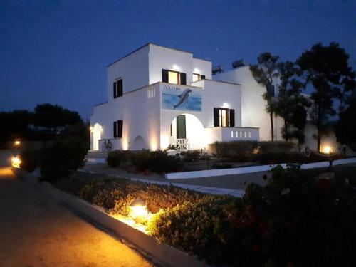 a large white building with lights in front of it at Dolphin Studios in Agia Anna Naxos