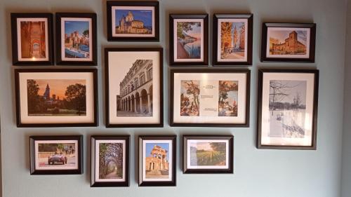 a group of pictures hanging on a wall at Il Fante di Picche in Verolanuova
