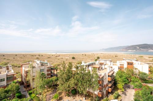 an aerial view of the beach and buildings at Aqualuz Troia Mar by The Editory in Troia