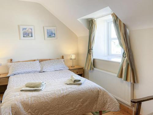 a bedroom with a bed with two towels on it at Sweetbriar Holiday Cottage by Trident Holiday Homes in Kilmore Quay