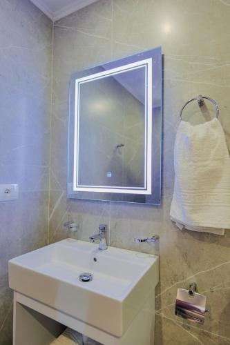 a bathroom with a white sink and a mirror at Hotel Milo Ksamil in Ksamil