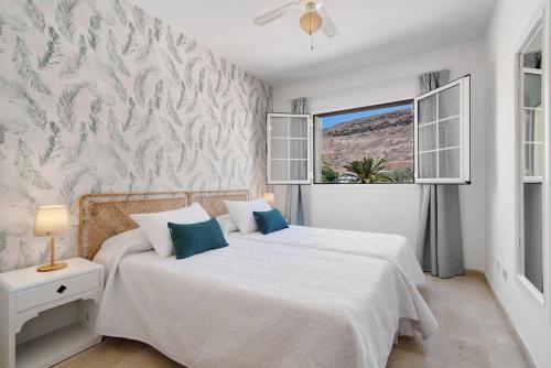 a bedroom with two beds and a window at Mangueros Suite 18 Puerto de Mogán in Puerto de Mogán
