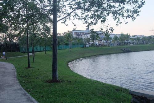 a park with a body of water and trees at Aleena's Guesthouse BSD City in Tangerang