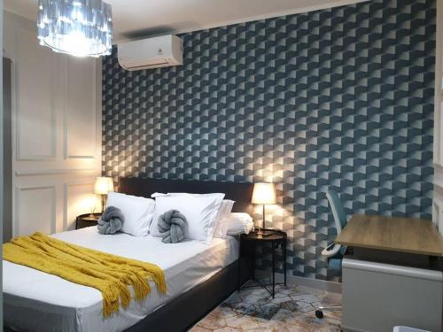 a bedroom with a bed with a yellow blanket on it at Chesya's Guesthouse BSD City in Tangerang