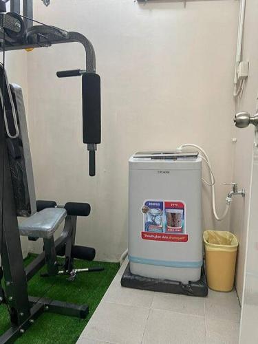 a water heater and a chair in a room at Chesya's Guesthouse BSD City in Tangerang