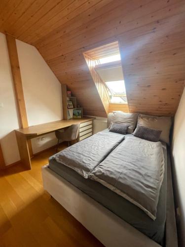 a bedroom with a bed and a desk in a attic at Villa Haškova with 3 bedrooms in Banská Bystrica