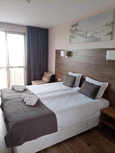 a hotel room with a large bed with two towels on it at Hotel Vanilla, Varna - Free parking in Varna City