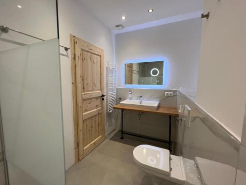 a bathroom with a sink and a mirror at Aparthotel Hochfeld in Schönau am Königssee