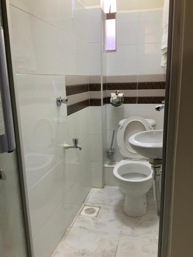 a bathroom with a toilet and a sink at Kije Place Hotel in Nairobi