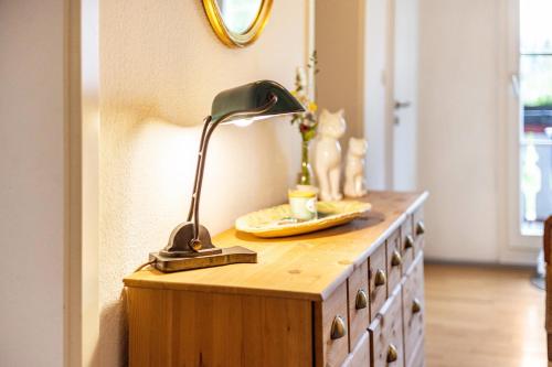 a desk with a lamp on top of a dresser at Klosterhof Eggenreute in Wangen im Allgäu