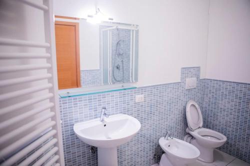 a bathroom with a sink and a toilet at CASA VACANZA ARAMARE 22 in Civitanova Marche