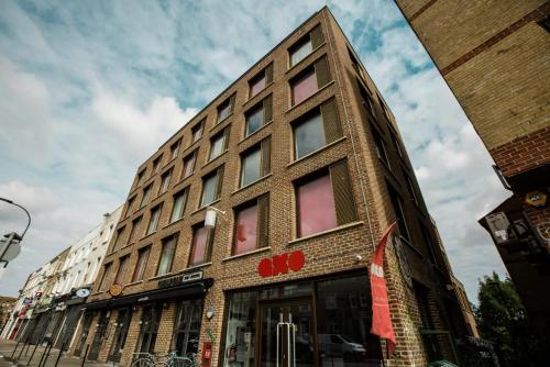a tall brick building on a city street at For Students Only Cosy Ensuites at New Cross in London in London