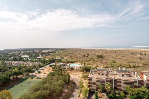 an aerial view of a residential neighbourhood with the ocean at Aqualuz Troia Mar by The Editory in Troia