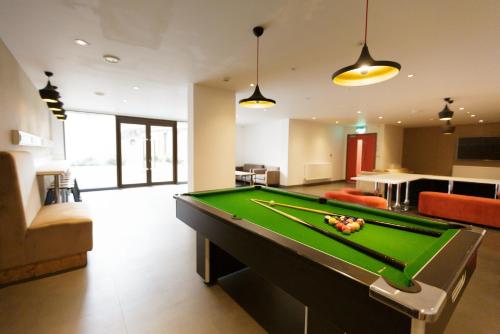 a living room with a pool table in it at For Students Only Cosy Ensuites at New Cross in London in London