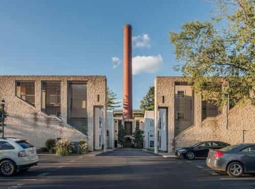 a factory with cars parked in a parking lot at Captain's Quarters Riverfront #3 in Nashville