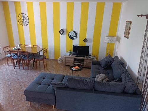 a living room with a blue couch and a table at Apartment Tea in Preko