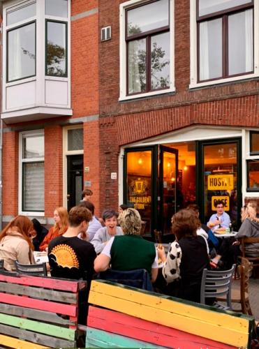 a group of people sitting outside of a restaurant at Hostel The Golden Stork in The Hague
