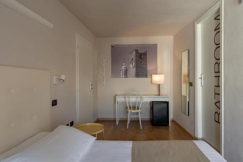a bedroom with a bed and a desk with a chair at Ca' Tazzoli in Mantova