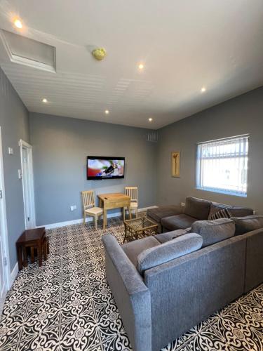 a living room with a couch and a table at City West Apartments 3 bedroom large & modern Apartment in Newcastle upon Tyne